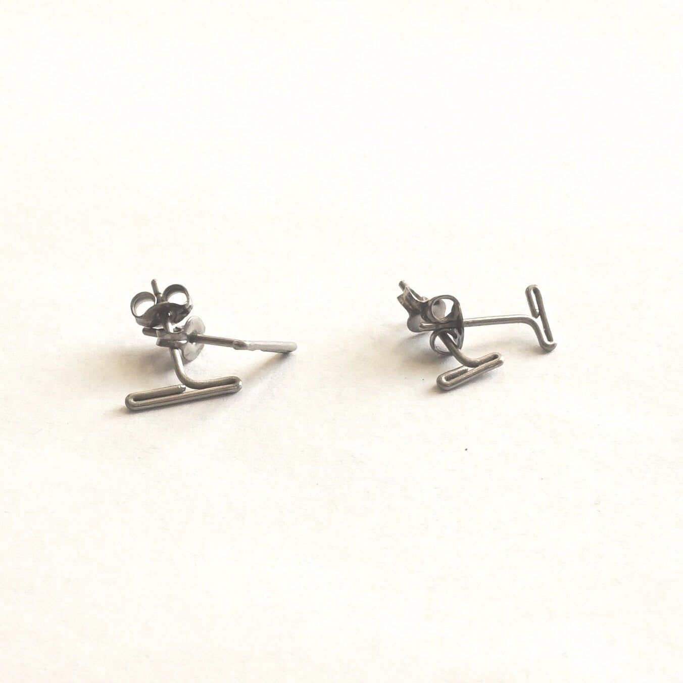 Two sets of hypoallergenic titanium earrings: Minimalistic design, available in 7mm and 11mm sizes. Perfect for everyday wear and sensitive ears.