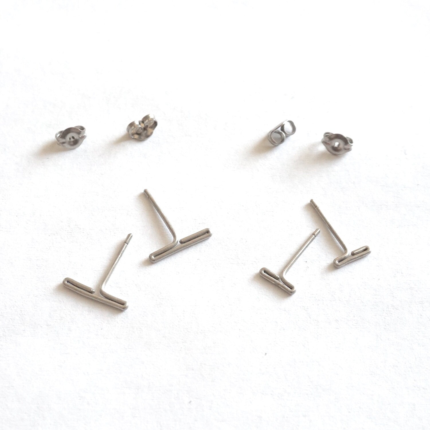 Two sets of hypoallergenic titanium earrings: Minimalistic design, available in 7mm and 11mm sizes. Perfect for everyday wear and sensitive ears.